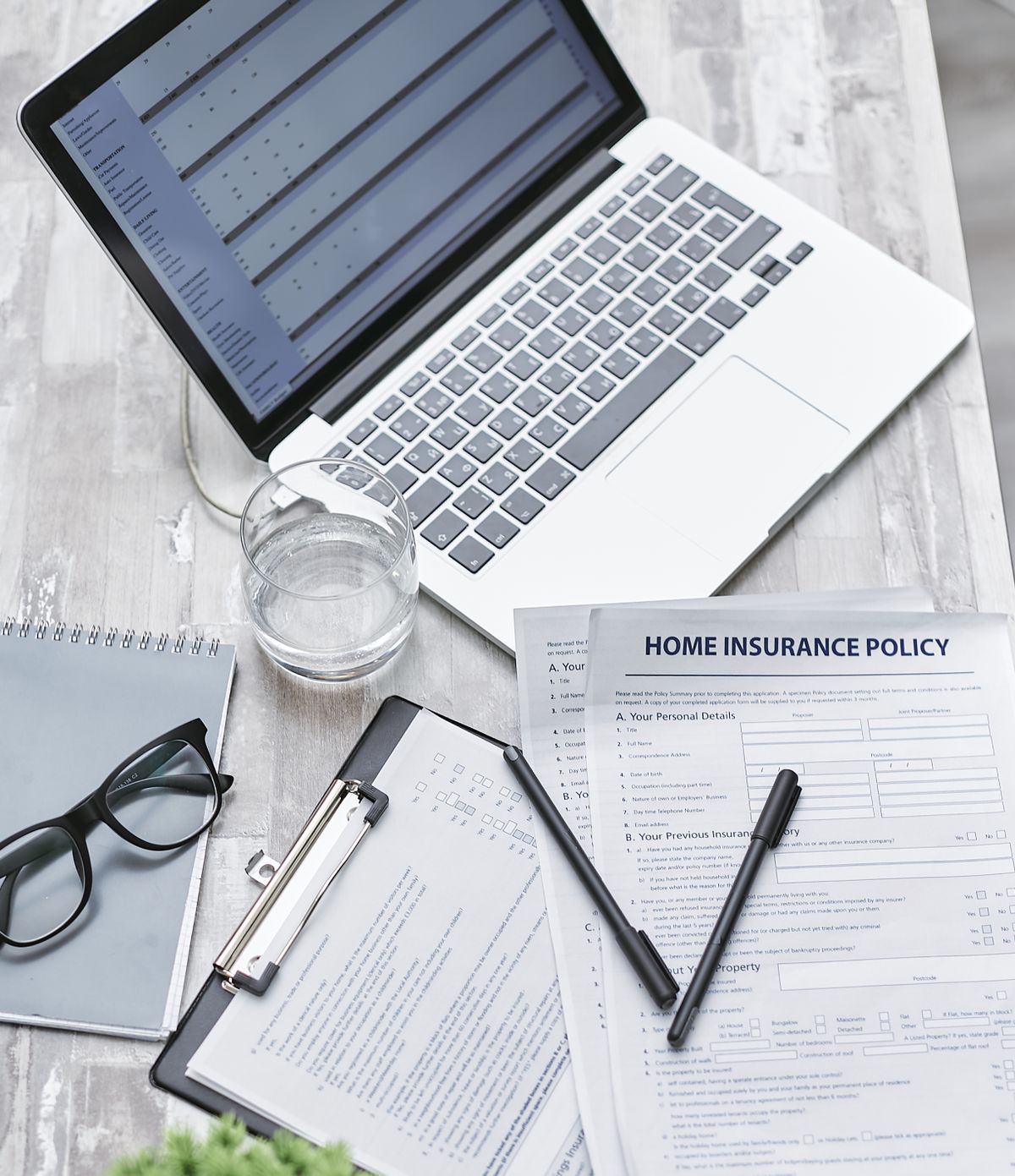 Desk with laptop and insurance policy documents used in case management